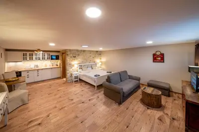 a large living room with a bed and a kitchen at Studio Flat - Sleeps 3 - Parking - Wifi in Hostivice