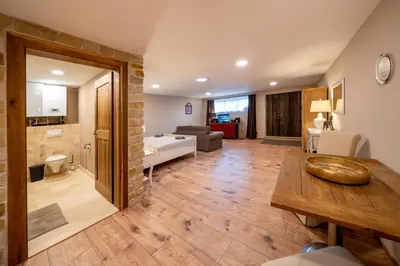 a large living room with a table and a couch at Studio Flat - Sleeps 3 - Parking - Wifi in Hostivice