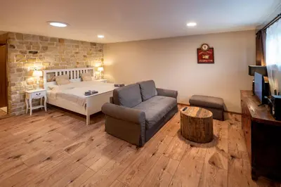 a living room with a bed and a couch at Studio Flat - Sleeps 3 - Parking - Wifi in Hostivice