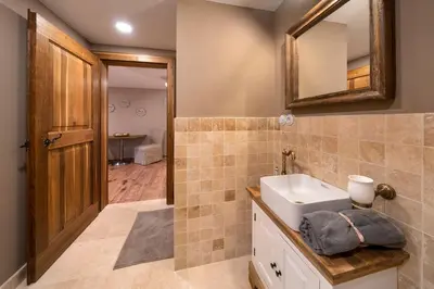 a bathroom with a sink and a mirror at Studio Flat - Sleeps 3 - Parking - Wifi in Hostivice