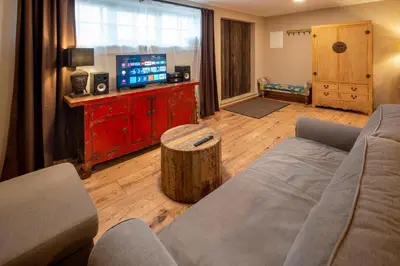 a living room with a couch and a tv at Studio Flat - Sleeps 3 - Parking - Wifi in Hostivice