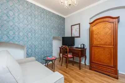 a living room with a couch and a desk with a tv at St Wenceslas House in Prague