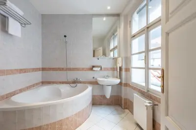 a bathroom with a tub and a sink at St Wenceslas House in Prague