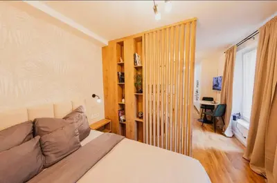 a bedroom with a bed and a desk in a room at Stylish Studio in the city center in Prague