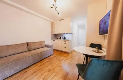 a living room with a couch and a table at Stylish Studio in the city center in Prague