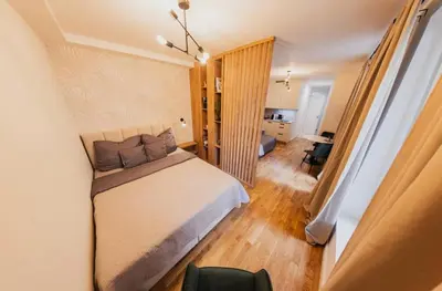 a bedroom with a bed and a living room at Stylish Studio in the city center in Prague