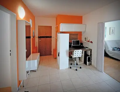a room with a bedroom with a desk and a computer at Pleasant apartment close to city center in Prague