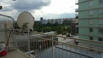 a balcony of a building with a satellite at Pleasant apartment close to city center in Prague