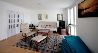 a living room with a couch and a chair at Pleasant apartment close to city center in Prague