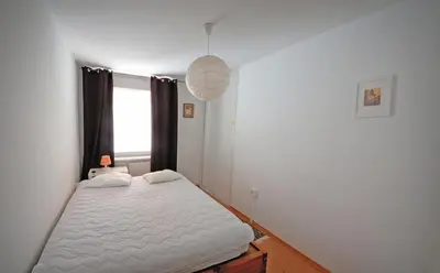 a bedroom with a white bed and a window at Pleasant apartment close to city center in Prague