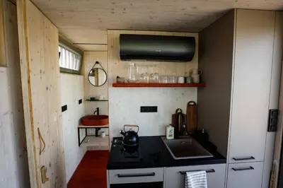 a small kitchen with a sink and a stove at Glamping Jezeroooo Lipence in Prague