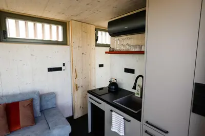 a small kitchen with a sink and a stove at Glamping Jezeroooo Lipence in Prague