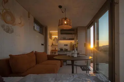 a living room with a couch and a table at Glamping Jezeroooo Lipence in Prague