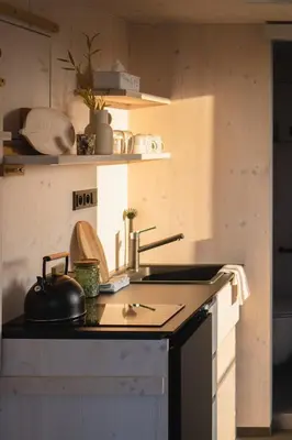a kitchen with a sink and a counter top at Glamping Jezeroooo Lipence in Prague