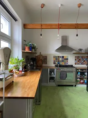a kitchen with a wooden counter top and a stove at Colorful apartman in Holešovice in Prague