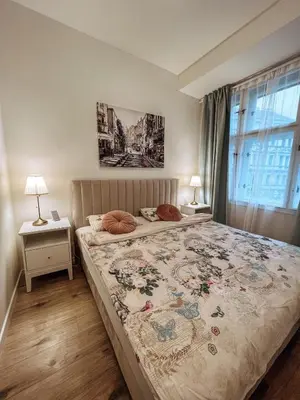 a bedroom with a large bed and a window at Stylish 1 bedroom plus office at amazing location in Prague