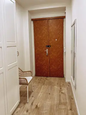 a door in a room with a chair and a door at Stylish 1 bedroom plus office at amazing location in Prague