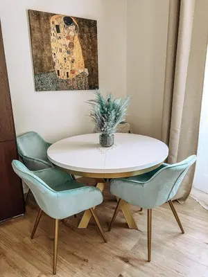 a dining room table with chairs and a plant on it at Stylish 1 bedroom plus office at amazing location in Prague