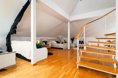 a room with a bed and stairs in a room at Kingdom River Deluxe in Prague