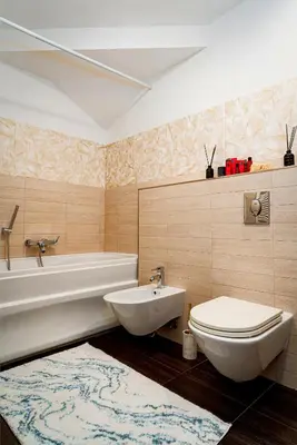 a bathroom with a tub and a toilet and a sink at Kingdom River Deluxe in Prague