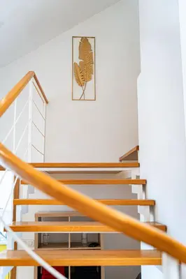 a wooden staircase in a house with a picture on the wall at Kingdom River Deluxe in Prague