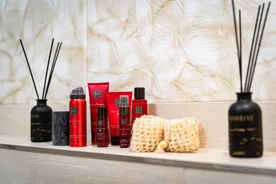 a shelf with four bottles ofodorizers and candles at Kingdom River Deluxe in Prague