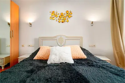 a bedroom with a black bed with orange pillows at Kingdom River Deluxe in Prague