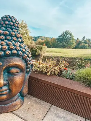 a statue of a head in a garden at Chata Miracle in Slapy