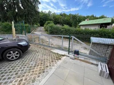 a car parked in a parking lot next to a fence at Chata Miracle in Slapy