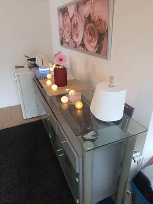 a desk with a lamp and candles on it at Devils Peak Prague in Prague