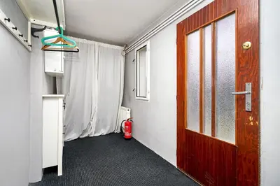 a hallway with a door and a fire hydrant in a room at Devils Peak Prague in Prague