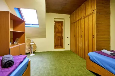 a bedroom with two beds and a window at Devils Peak Prague in Prague