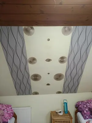 a ceiling in a room with two beds at Devils Peak Prague in Prague