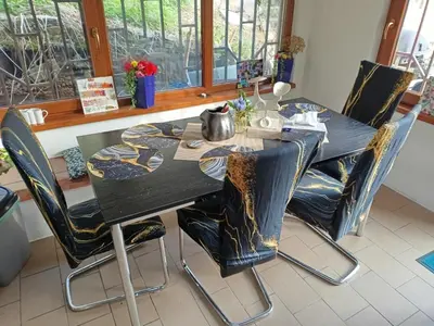 a dining room table with chairs and a black table at Devils Peak Prague in Prague