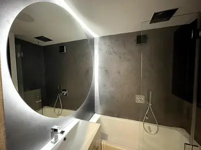 a bathroom with a mirror and a sink and a tub at Super central Prague apartment SUPERHOST 5 stars in Prague