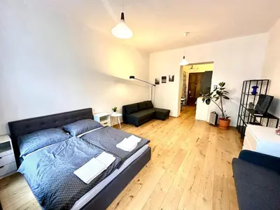 a bedroom with a bed and a couch in a room at Super central Prague apartment SUPERHOST 5 stars in Prague