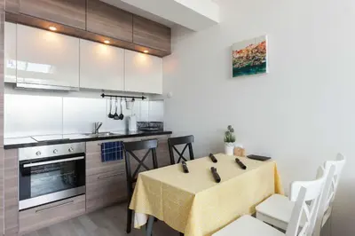 a kitchen and dining room with a table and chairs at Kent Ridge Loft, Sokolska in Prague