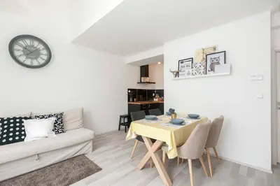 a living room with a table and a couch at Kent Ridge Loft, Sokolska in Prague