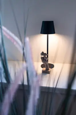 a lamp sitting on top of a table next to a bed at Duplex 165m2 with VIEWS only 30 Seconds to Charles Bridge in Prague
