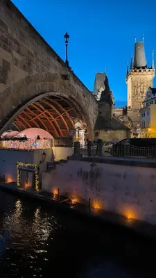 a bridge over a river in a city at night at Duplex 165m2 with VIEWS only 30 Seconds to Charles Bridge in Prague