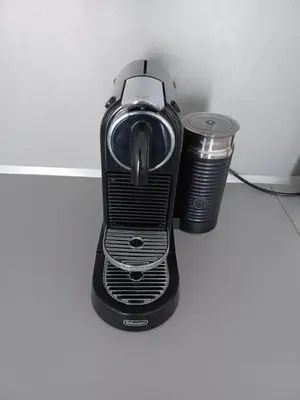a black blender and a cup on a counter at Apartment Husova in Poděbrady