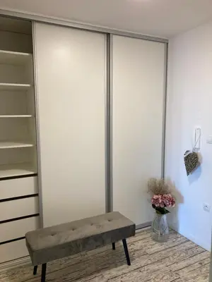 a bench in a room with a closet at Apartment Husova in Poděbrady