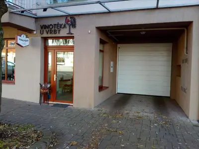 a garage entrance to a building with a white garage door at Apartment Husova in Poděbrady