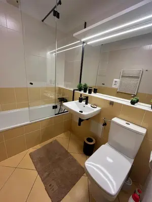 a bathroom with a white toilet and a sink at Family Arena Prague in Prague
