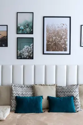 a living room with a couch and framed pictures on the wall at Family Arena Prague in Prague