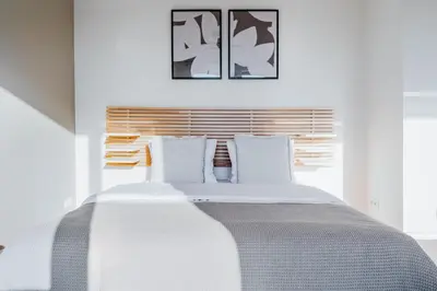 a white bed with white pillows in a bedroom at Blueground Žižkov furnished park PRG-42 in Prague