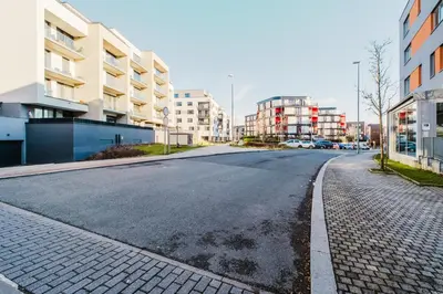 an empty street in a city with tall buildings at Blueground Žižkov furnished park PRG-42 in Prague