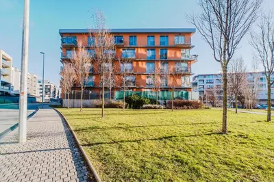 a building in a city with trees in a park at Blueground Žižkov furnished park PRG-42 in Prague