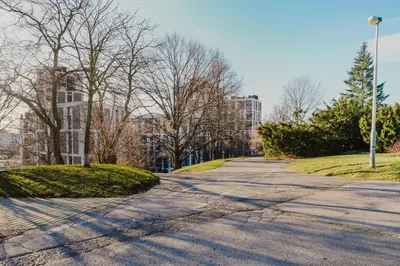 an empty street in a city with trees and buildings at Blueground Žižkov furnished park PRG-42 in Prague