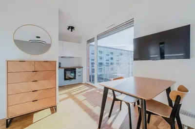 a kitchen and dining room with a table and a window at Blueground Žižkov furnished park PRG-42 in Prague